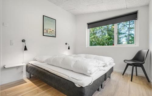 エーベルトフトにあるStunning Home In Ebeltoft With 6 Bedrooms And Wifiのベッド1台(椅子、窓付)