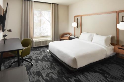 Fairfield Inn & Suites by Marriott Stony Creek في Stony Creek: غرفة الفندق بسرير كبير ومكتب