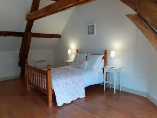 a bedroom with a bed and a wooden floor at Gites Les Coudreaux in Saint-Siméon