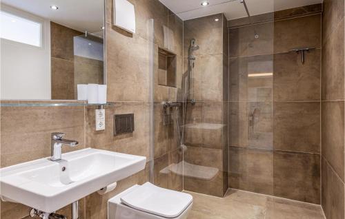 a bathroom with a toilet and a sink and a shower at Pearl in Binz