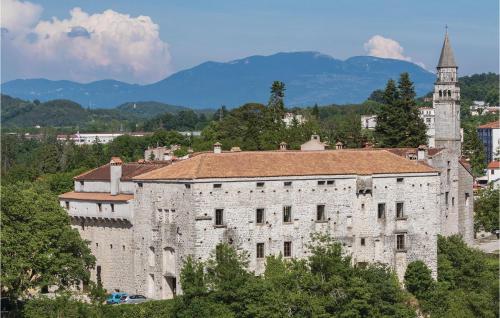 a large stone building with a clock tower in a city at 6 Bedroom Cozy Home In Pazin in Brajkovići