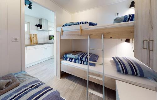 two bunk beds in a small room with a kitchen at Awesome Ship In Aalsmeer With Lake View in Aalsmeer