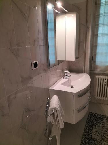 a bathroom with a white sink and a mirror at BUENOS AYRES 45 in Chiavari
