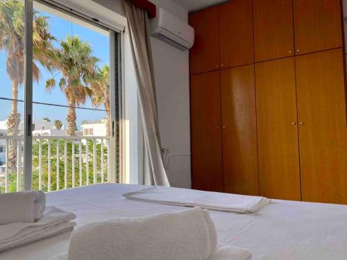 a bedroom with a bed and a large window at Elgreco Apartment, with nice view, in Kos Town "12" in Kos Town