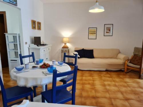a living room with a table and chairs and a couch at Chicca sul lago di Bolsena in Bolsena