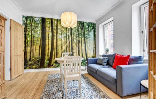 a living room with a couch and a window with trees at 1 Bedroom Cozy Apartment In Aarhus C in Aarhus