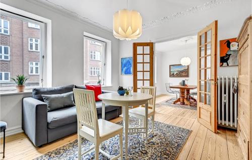 a living room with a table and a couch at 1 Bedroom Cozy Apartment In Aarhus C in Aarhus