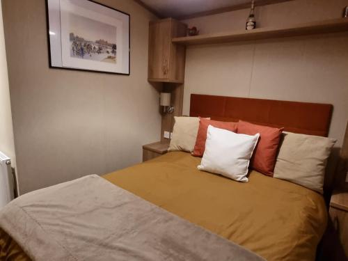 a bedroom with a bed with two pillows on it at Kimadalyn in Forfar