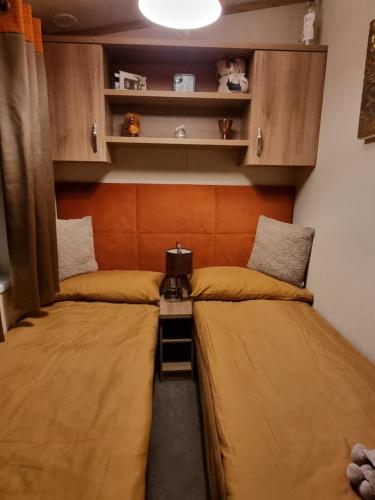 two twin beds in a room with cabinets at Kimadalyn in Forfar