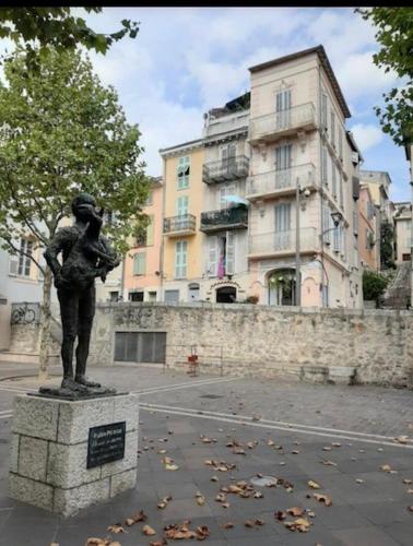 a statue of a woman holding a child in front of a building at Spacious Apartment in Vallauris for Art Lovers in Vallauris