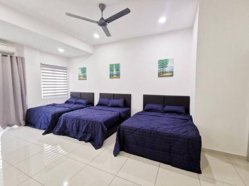 a bedroom with two beds and a ceiling fan at Bdr Seri Botani ipoh-nordic (tvbox/mahjong 19pax) in Ipoh