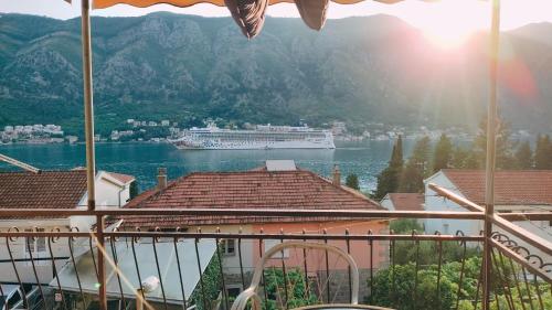 a cruise ship in a body of water at Apartments Peranovic in Kotor