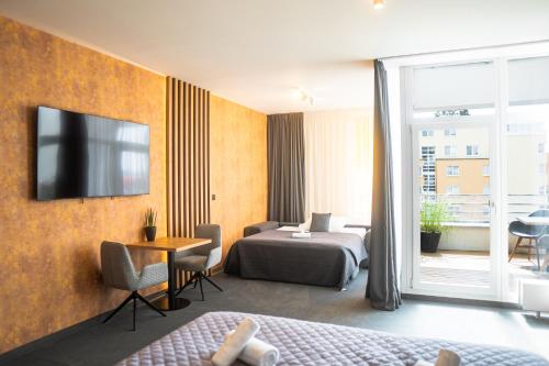 a hotel room with a bed and a television at Hotel JeštěBrno in Brno