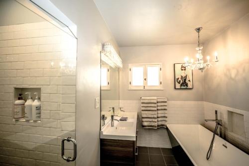 a bathroom with a tub and a sink and a bath tub at Gorgeous Renovated 3BD 2BA near West Hollywood and Beverly Hills in Los Angeles