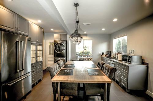 a large kitchen with a wooden table and chairs at Gorgeous Renovated 3BD 2BA near West Hollywood and Beverly Hills in Los Angeles