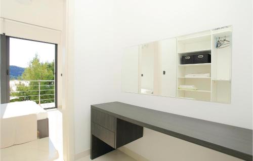baño con espejo grande y escritorio en Lovely Home In Karbuni With Kitchen, en Prizba