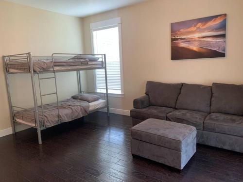 a living room with a couch and a bunk bed at 30A Coastal Home Walk to Beach, Lake & Pool in Inlet Beach