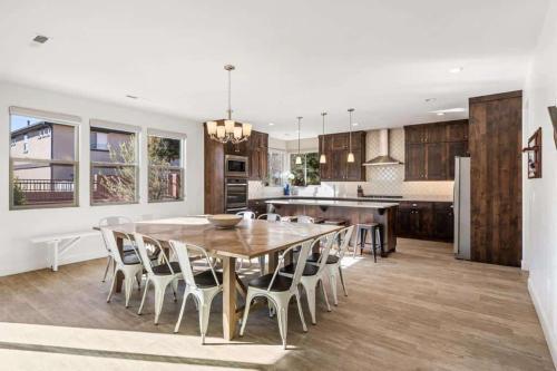 a kitchen and dining room with a wooden table and chairs at Desert Solitaire #101 in Santa Clara