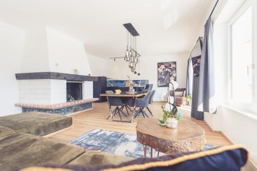 a living room with a couch and a fireplace at Anna Pertl - lieblingsquartier in Sankt Gilgen