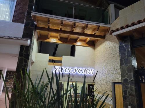 a sign for a restaurant on the side of a building at Hotel Tierras Blancas in Valle de Bravo