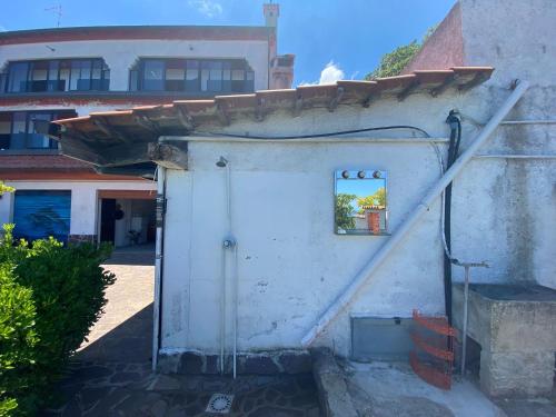 a white building with a door and a window at Casa Morello in Zambrone