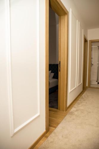 an open door leading into a room with a bedroom at Room21 FREE GARAGE in Novi Sad