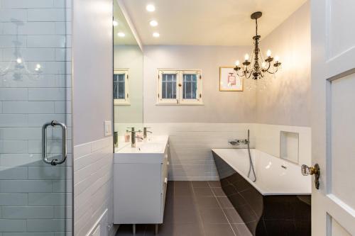 une salle de bain avec une baignoire, un lavabo et une douche dans l'établissement Renovated Spanish 3BD 2BA near Beverly Hills, à Los Angeles