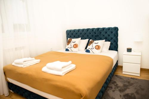 a bedroom with a bed with towels on it at Room21 FREE GARAGE in Novi Sad