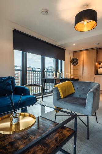a living room with a couch and a table at City View - A Stunning 2 Bed Apartment in Glasgow