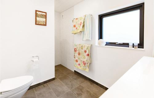 bagno bianco con servizi igienici e finestra di 5 Bedroom Nice Home In Rrvig a Rørvig