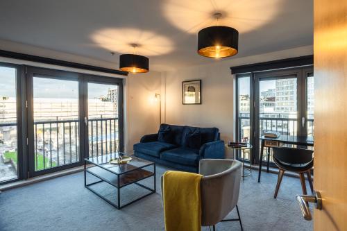 a living room with a couch and a table at City View - A Stunning 2 Bed Apartment in Glasgow