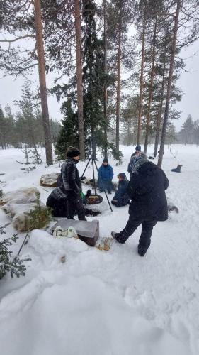 a group of people sitting in the snow at Villa Fregn in Ljørdal
