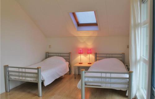 2 camas en una habitación con ventana en It Soal Waterpark-waterlelie, en Workum