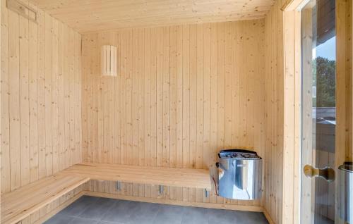 a sauna with a trash can in the corner at Nice Home In Hvide Sande With Sauna in Bjerregård
