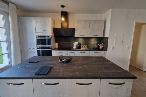 a kitchen with a large island in the middle at Appartement Chic Gold - 5min Disneyland in Serris