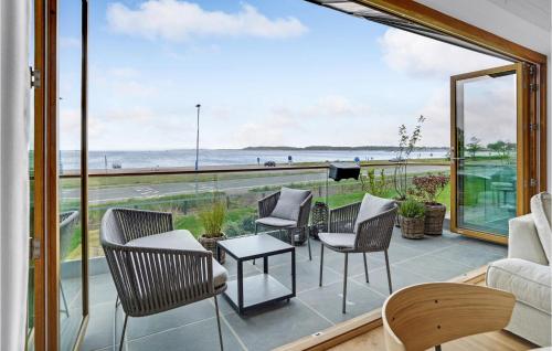 a balcony with chairs and tables and a view of the ocean at Cozy Apartment In Kerteminde With Wifi in Kerteminde