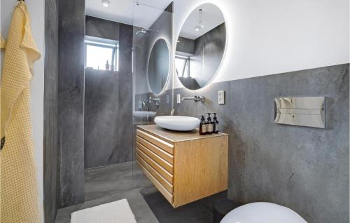a bathroom with a sink and a mirror at Awesome Apartment In Kerteminde With House Sea View in Kerteminde