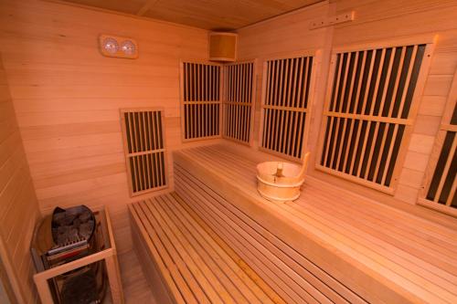 a large wooden sauna with a bucket in it at Gościniec Tokarzonka in Istebna