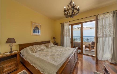 a bedroom with a bed and a large window at Lovely Home In Kostrena With Kitchen in Kostrena