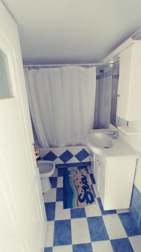a bathroom with a toilet and a sink at Sea view in Karpathos Town