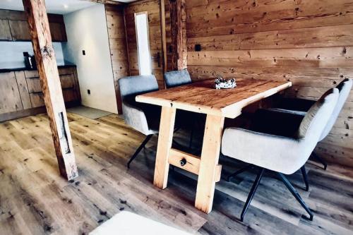 a wooden table and chairs in a room at Luxury & Cosy 3.5 rooms apartment in almost 300 years old Chalet in Leukerbad