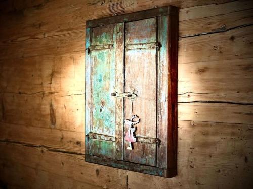 a wooden wall with a door with a teddy bear on it at Luxury & Cosy 3.5 rooms apartment in almost 300 years old Chalet in Leukerbad