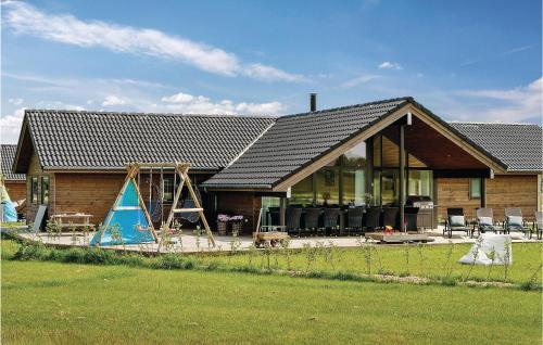 a house with a playground in front of it at Four-Bedroom Holiday Home In Odder in Odder