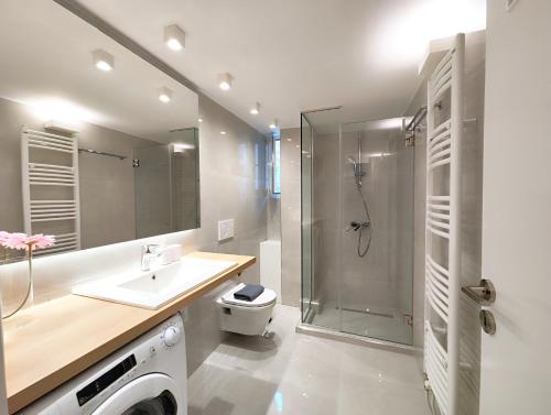 a bathroom with a shower and a sink and a toilet at Etolou A2 - by Verde Apartments in Athens