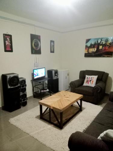 a living room with a couch and a coffee table at MASONKO Luxury Homes - Kakamega in Kakamega