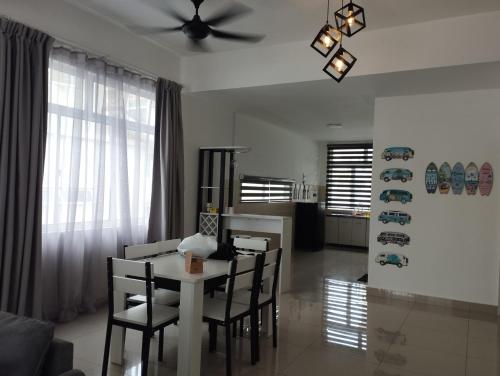 a kitchen and dining room with a table and chairs at Desaru coast Waterpark and Beach in Desaru