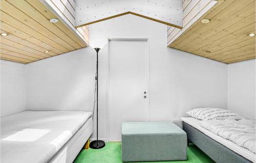 a room with two beds and a lamp at Awesome Home In Egå With Kitchen in Egå