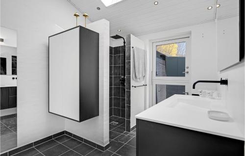 a white bathroom with a shower and a sink at Awesome Home In Eg With Kitchen in Egå