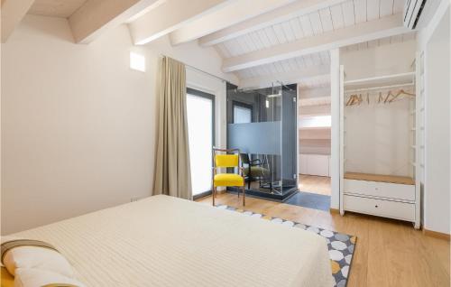a bedroom with a bed and a yellow chair at Lovely Home In Alviano With Kitchen in Alviano