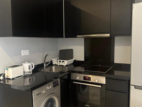a kitchen with a washing machine and a sink at Twin Center Oasis - Luxury Apartment with Free Parking in Casablanca